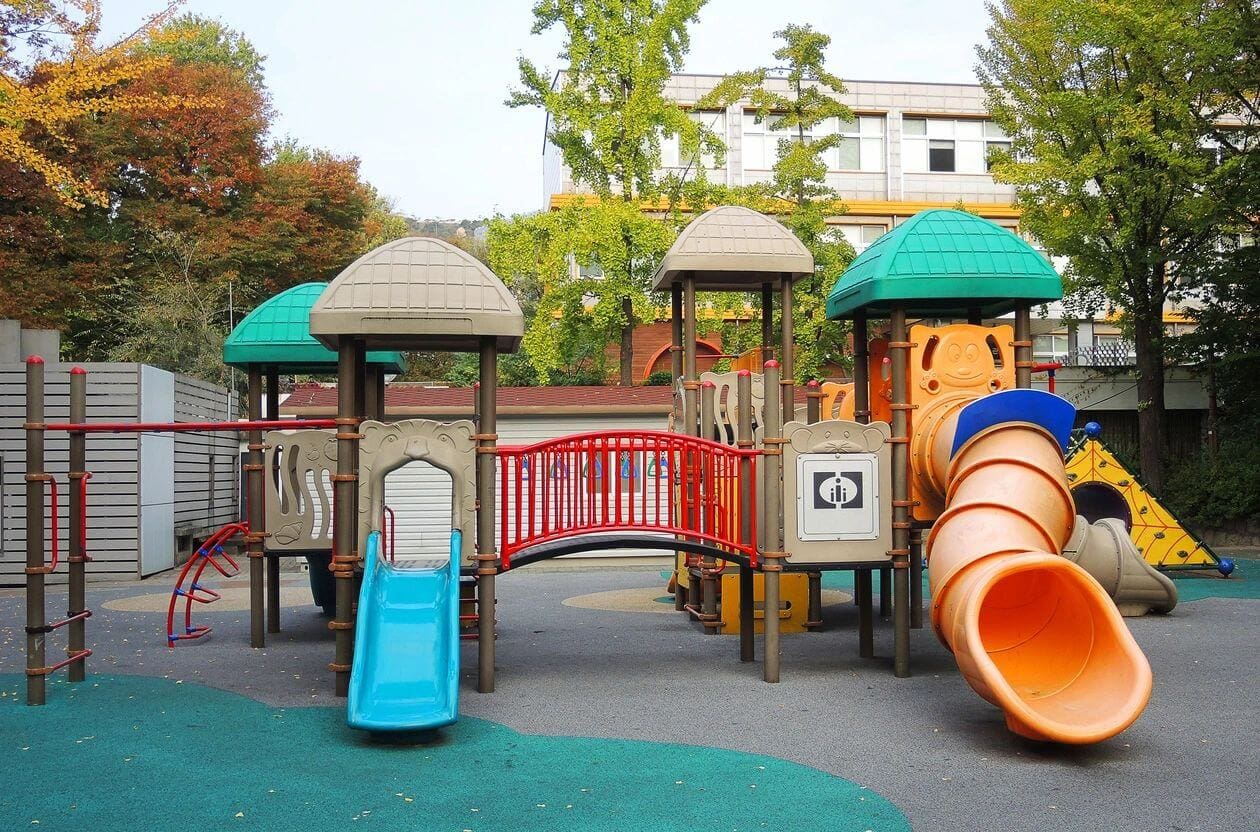 A playground with slides and swings for children.